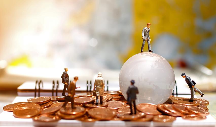 Figurines of EB5 service providers placed on a pile of coins and an immigrant investor standing on a globe.