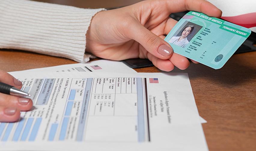 A conditional green card holder filling in their details in a permanent green card application form.
