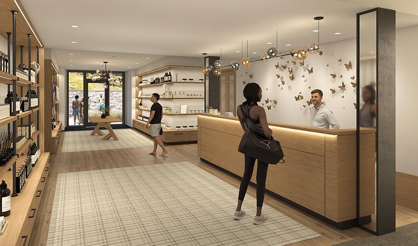 A person standing in front of a reception desk at the SR sporting club.