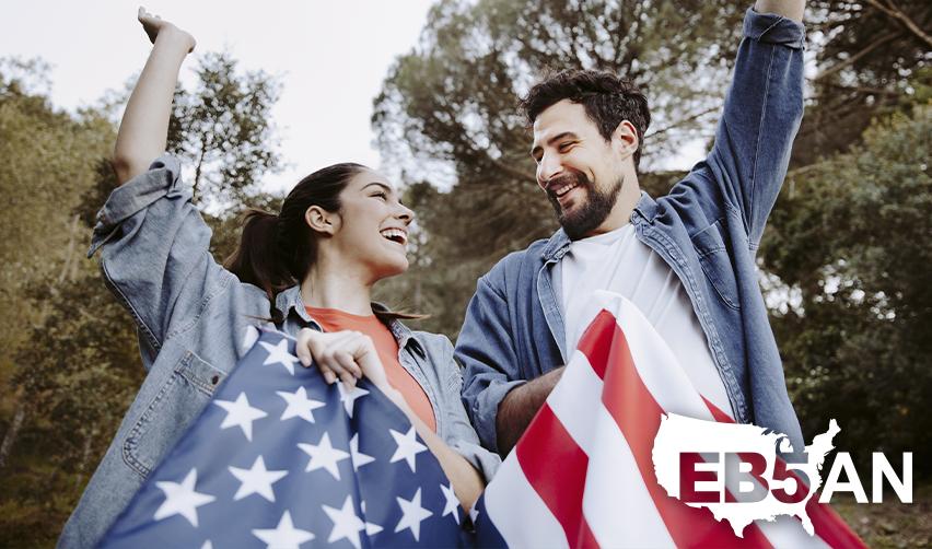 Two alien entrepreneurs celebrating their permanent residency status with American flags.