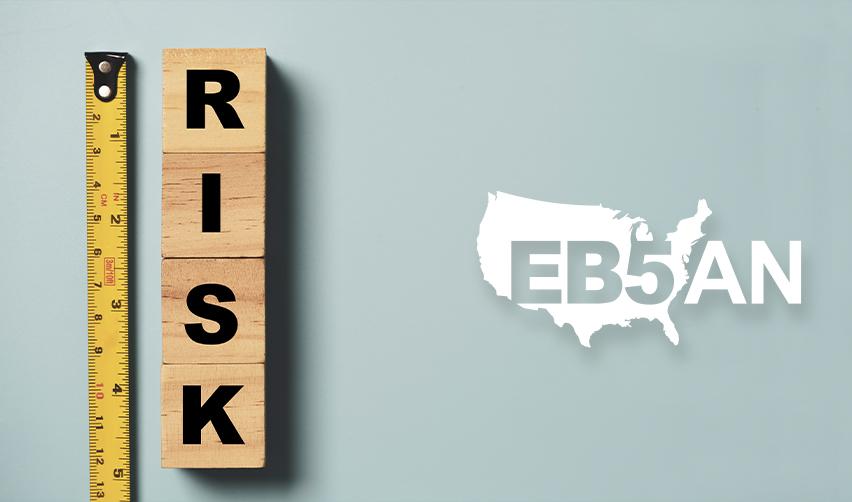Wooden blocks spelling out risk, next to the EB5AN logo.