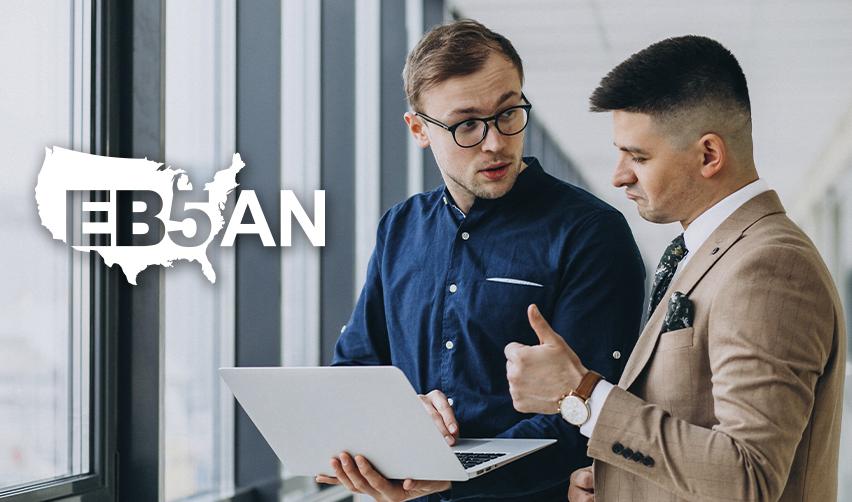 An EB5 regional center industry professionals explaining the EB5 timeline to an alien entrepreneur on the computer, next to the EB5AN logo.