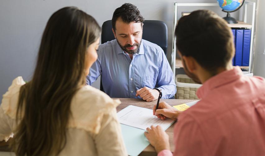 A group of EB5 investors filling out some visa application forms at a regional center office.
