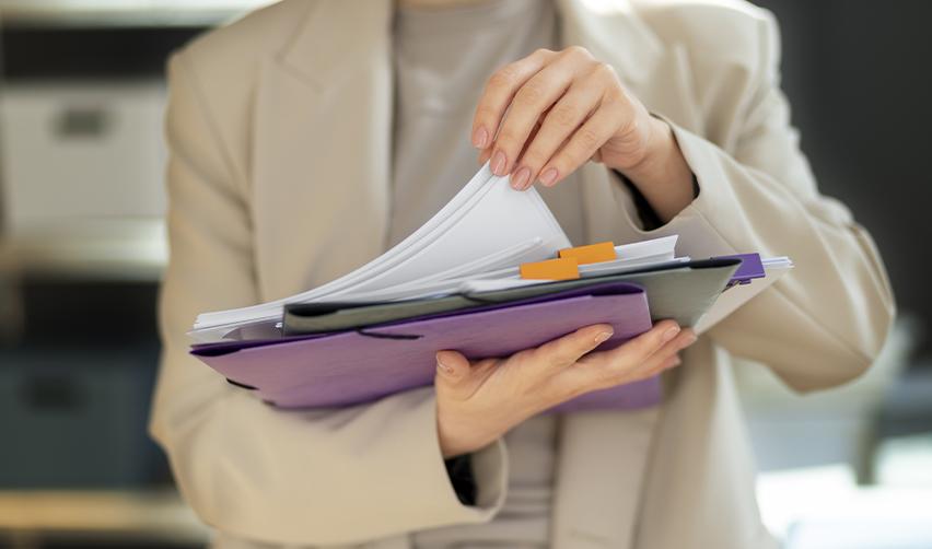 An E-3 visa holder going over her E-3 documents to proceed with her green card application.