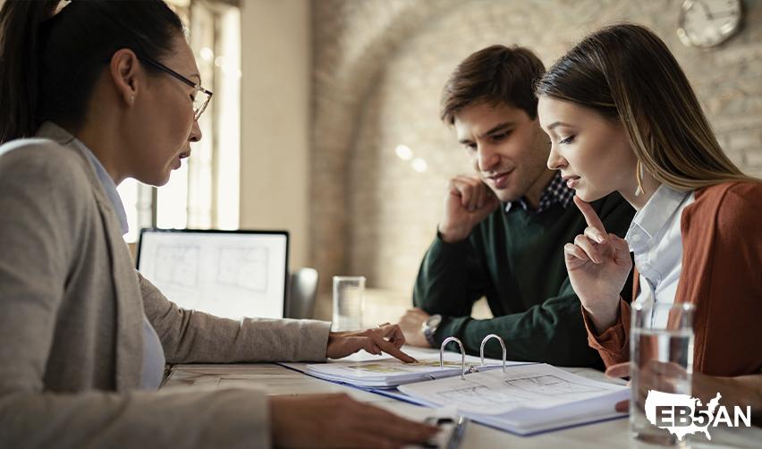 A couple of Australian EB5 investors listening to a regional center principal explain the green card application process.