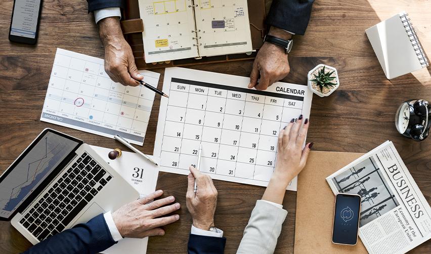 Regional center team reviewing monthly calendars and planning EB5 visa filings before visa retrogression deadlines.