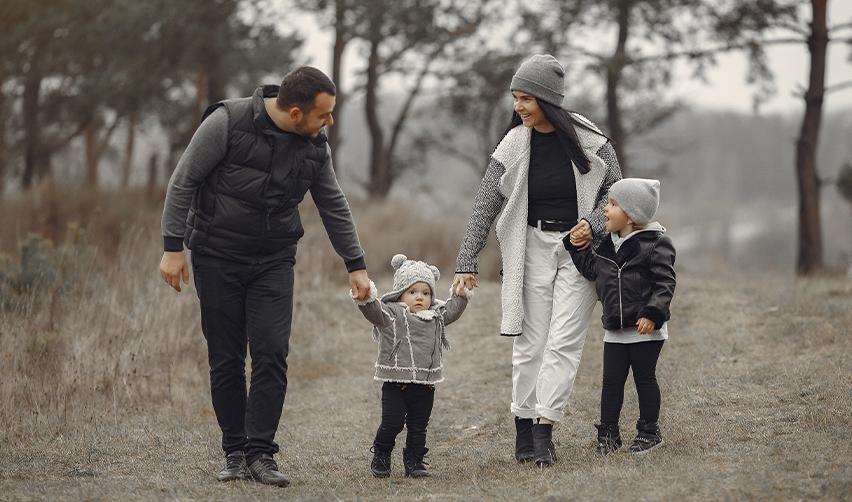 Israeli family walking together in a scenic outdoor setting, symbolizing the pursuit of a better future and the benefits of U.S. permanent residency through the EB5 program.