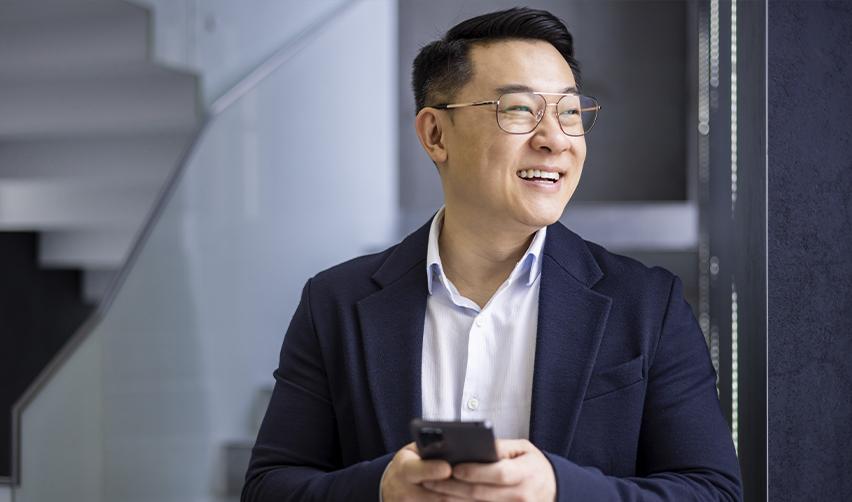 Confident Chinese EB5 investor smiling after filing through a current set-aside visa category to avoid retrogression.