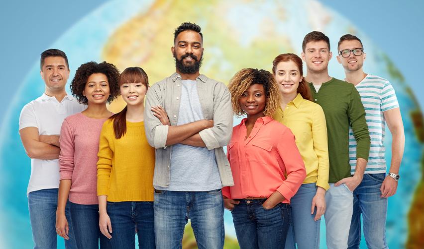 Group of diverse, smiling individuals standing together in front of a world map, representing the global demand for the EB5 visa among investors from China, India, Vietnam, Latin America, and the Middle East.