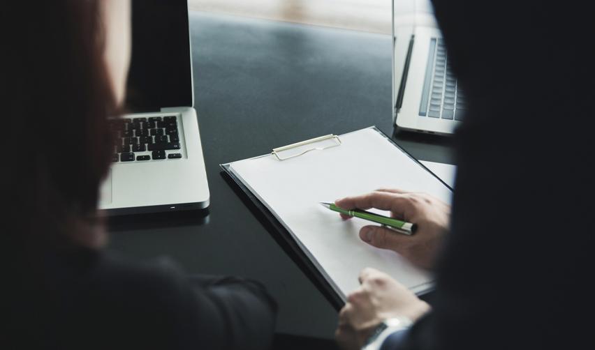 EB5 applicant reviewing documents with an expert, highlighting the importance of professional assistance to avoid USCIS RFEs during the investment process.