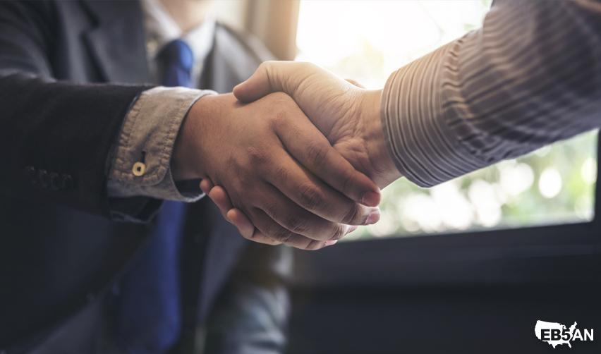 EB5AN team member shaking hands with investor to support compliance with EB5 at-risk investment rules.