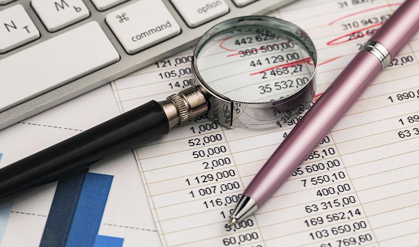 Close-up of financial statements under review, symbolizing EB5 fund tracing, accuracy checks, and USCIS RFE risk mitigation.