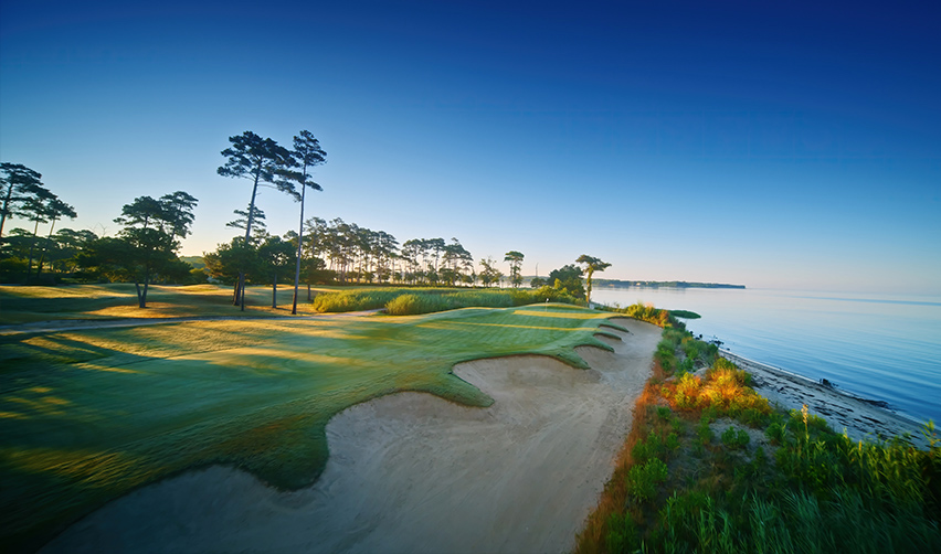 A golf course with a sand bunker