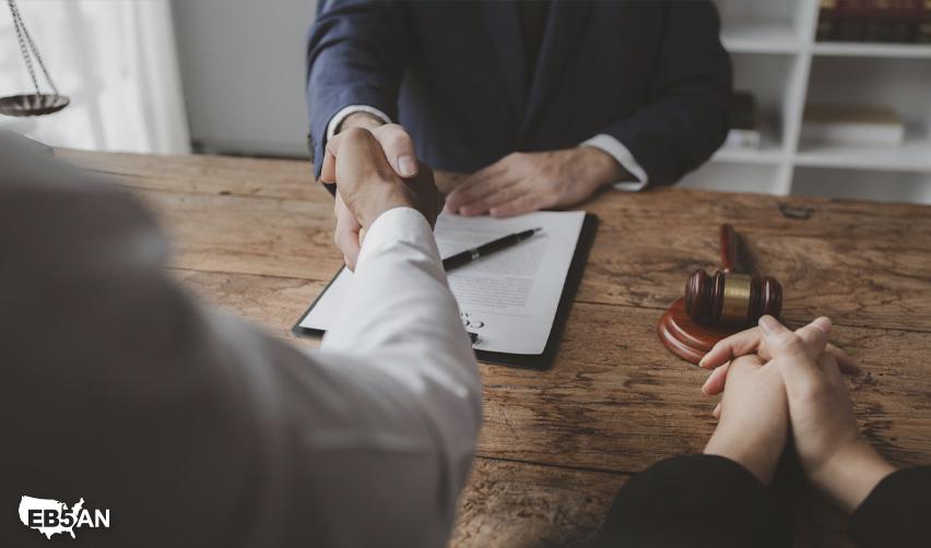 The EB5AN logo next to a client and attorney shaking hands at a desk with a gavel, reflecting trust and the beginning of an EB5 partnership.