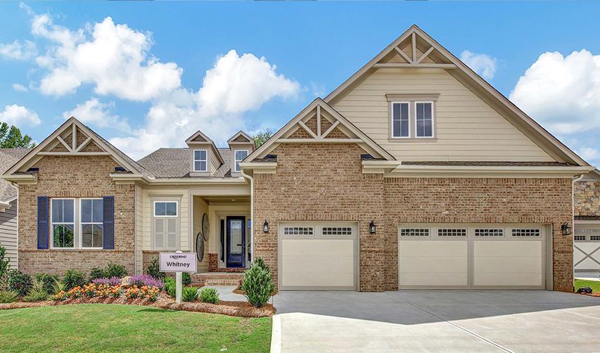A house with a driveway and a sign