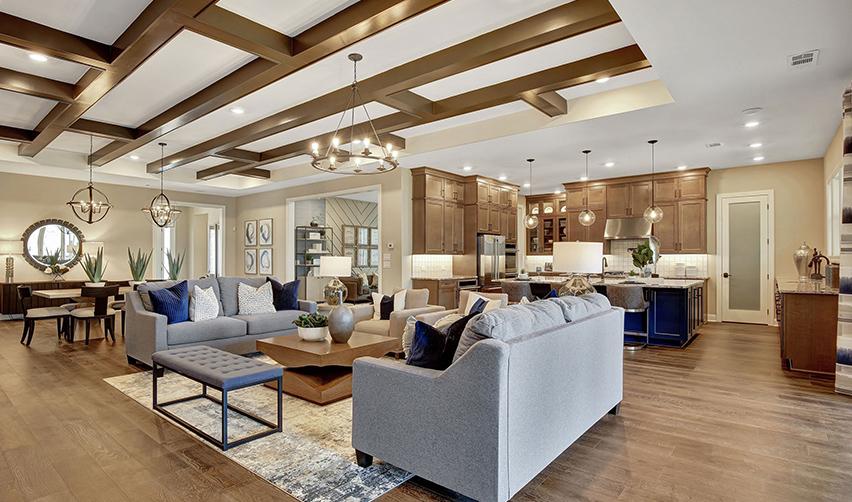 A living room with a kitchen and dining area