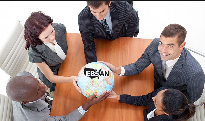 Business team holding a globe marked with the EB5AN logo, representing global investors choosing EB5AN projects backed by strong reporting and transparency.