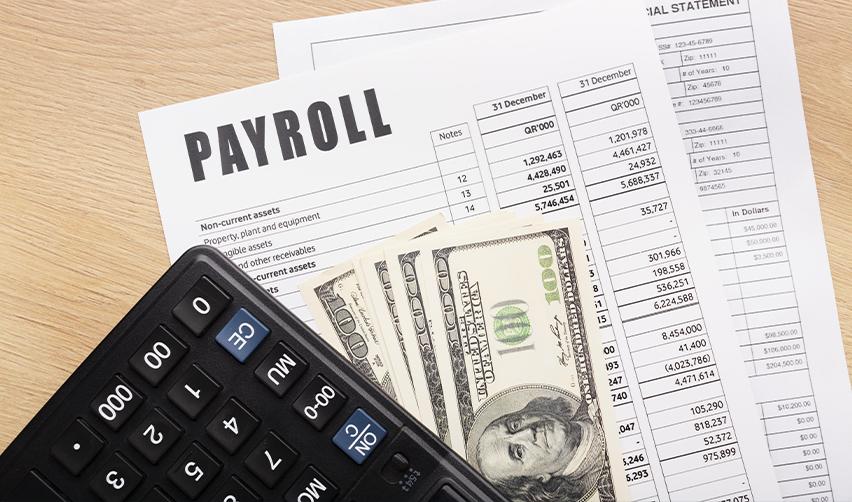 Payroll documents with financial statements, calculator, and U.S. dollars symbolizing direct job verification in EB5 projects.