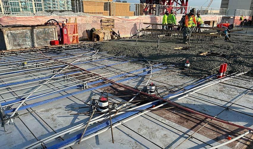 A close-up of conduit and MEP systems laid across a concrete deck at ONE Tampa, with crews preparing for a major slab pour as part of ongoing structural work on the EB5 development.