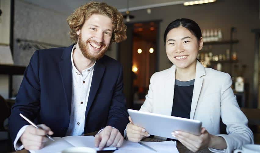 Two professionals reviewing documents together, representing EB5 investors working with immigration and financial advisors during the application process.