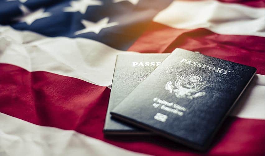 U.S. passports placed on an American flag, representing permanent residency and citizenship outcomes through the EB5 immigrant investor program.