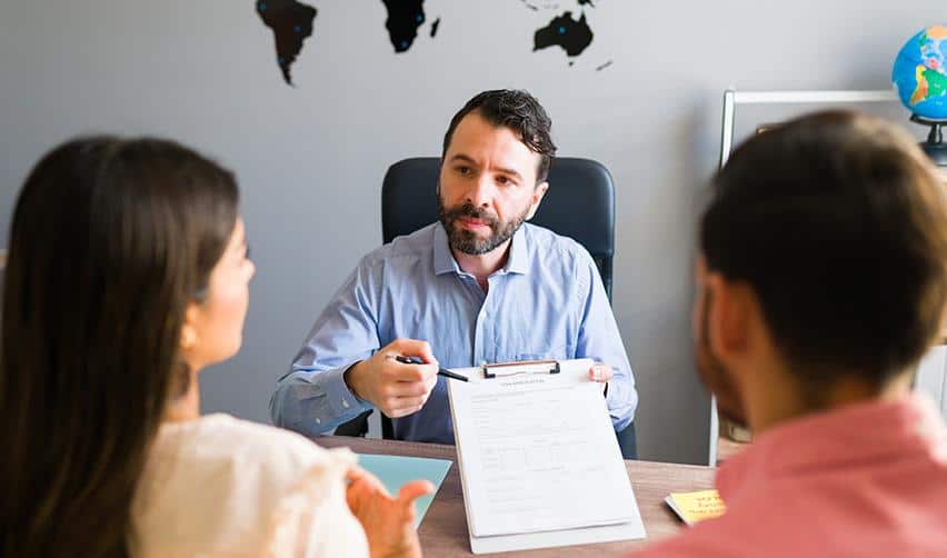 An immigration advisor reviewing documents with a couple during an EB5 consultation, highlighting the importance of guidance and education before investing.